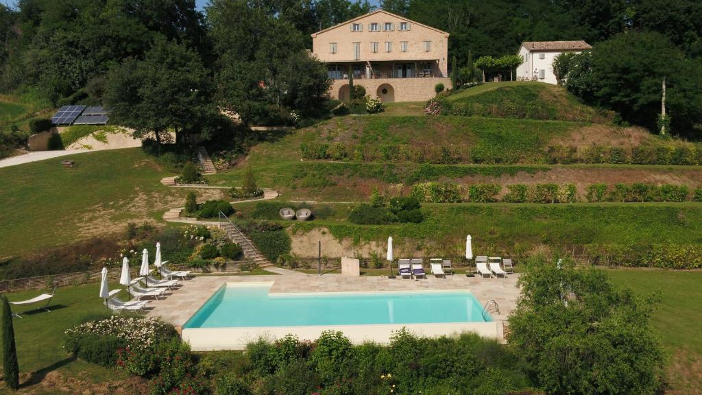 an aerial view of a house with a swimming pool at La Giravolta Country House in Barchi