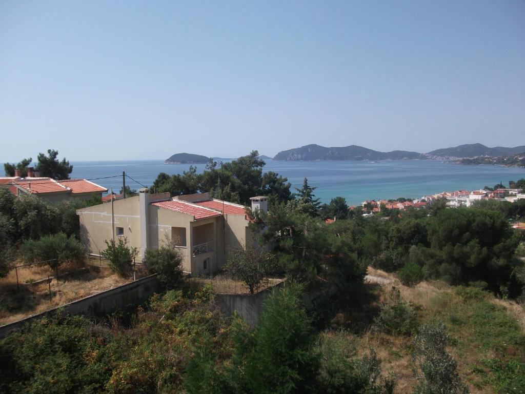 a house on a hill with a view of the water at Konstantina’s House in Paleo Tsifliki