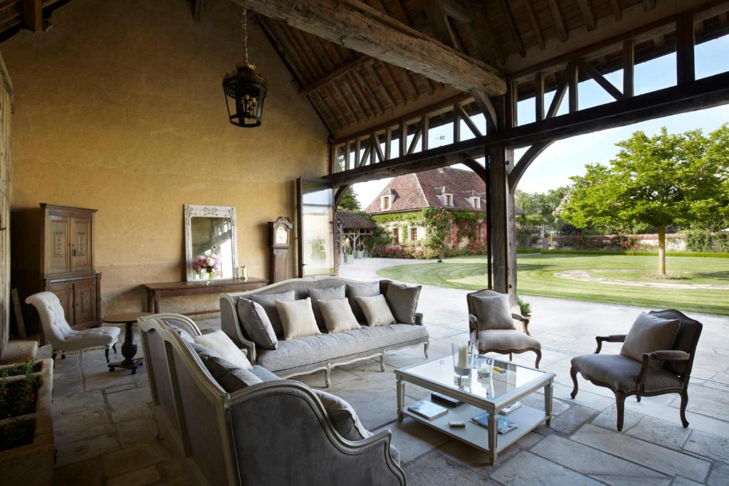 een woonkamer met een bank, stoelen en een tafel bij La Borde - Teritoria in Leugny