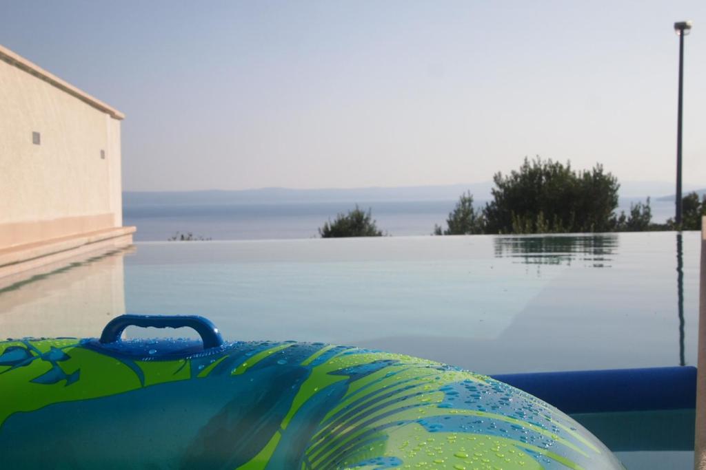 a view of a pool with a ball in the water at Open Hus in Krvavica