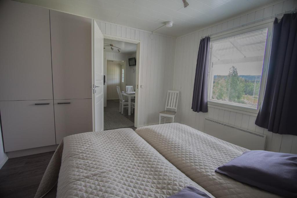 a bedroom with a bed and a window and a table at Paimentupa in Kolinkylä