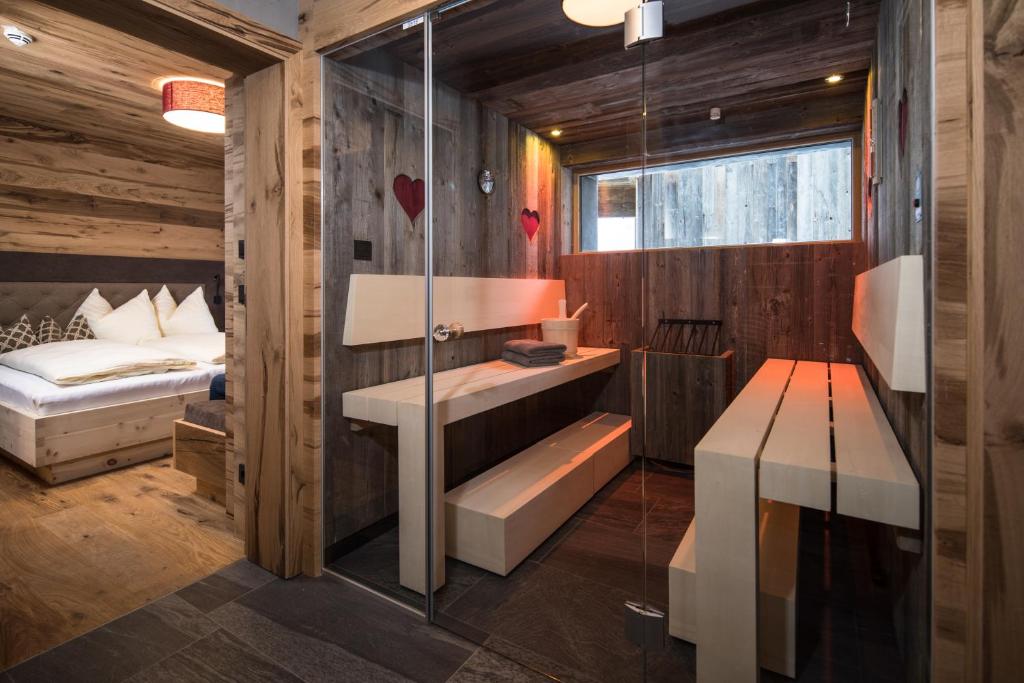 sypialnia z łóżkiem i szklaną ścianą w obiekcie Stadl Lofts Plattenalm - Premiumchalets - Zillertal - Tirol - Salzburg w mieście Krimml
