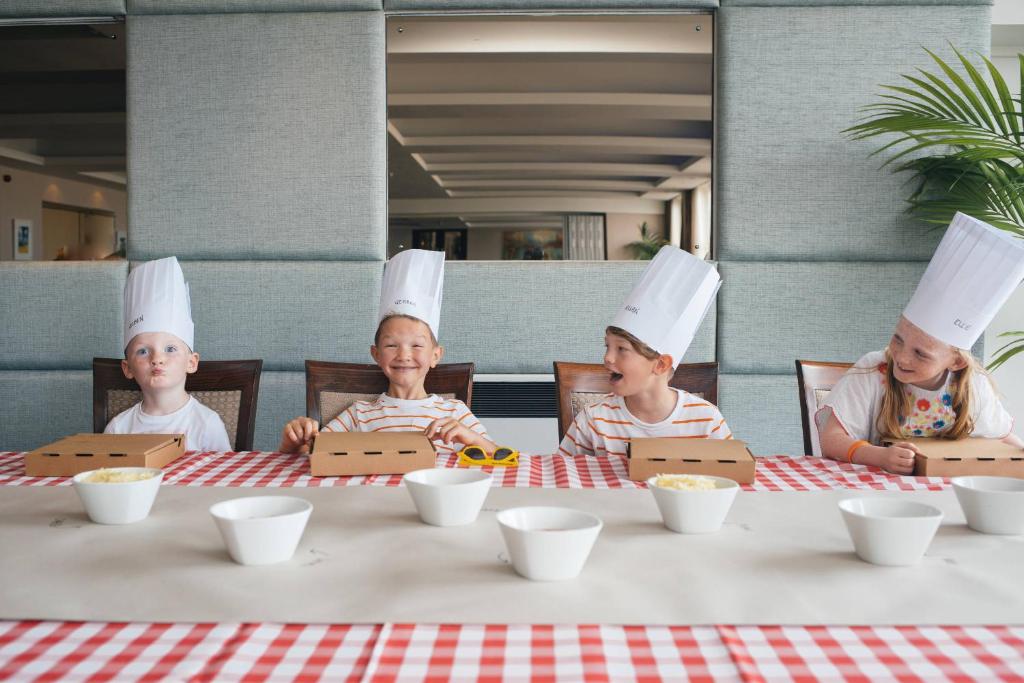three people wearing chefs hats sitting at a table at Esplanade Hotel in Newquay