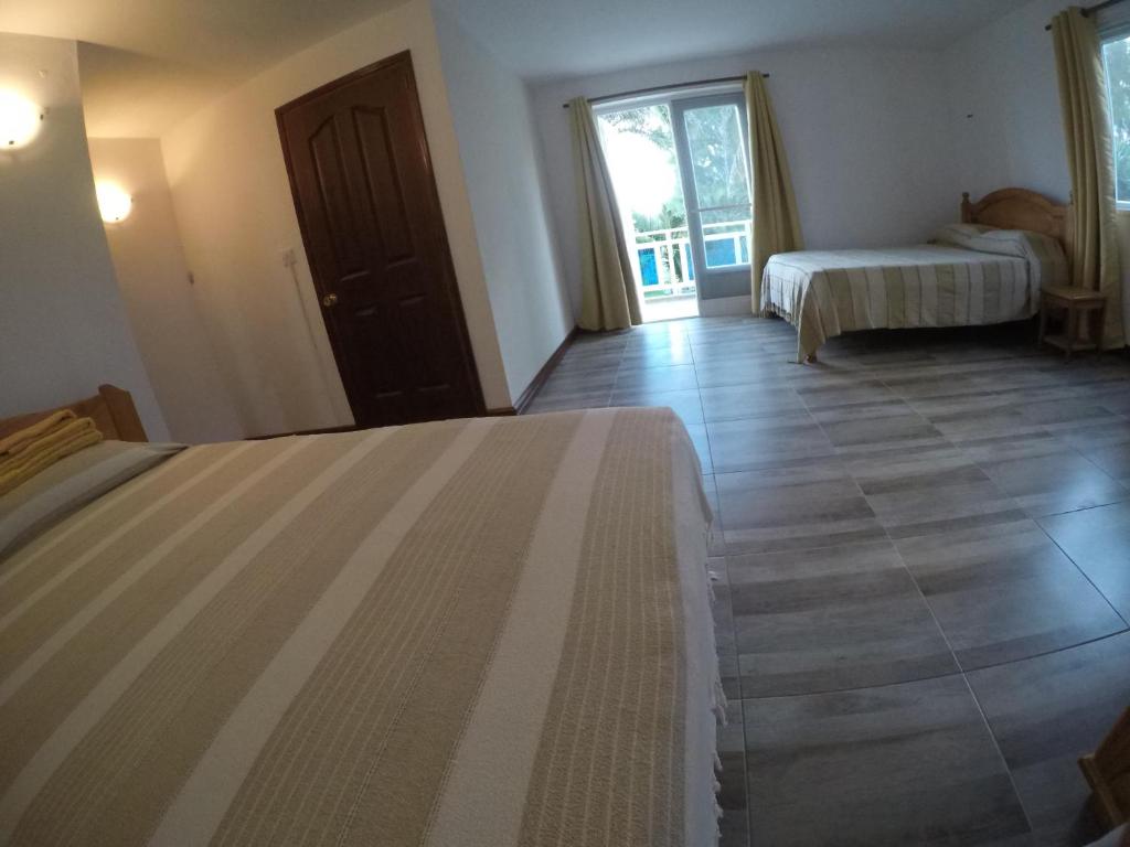 Postel nebo postele na pokoji v ubytování Tibambari