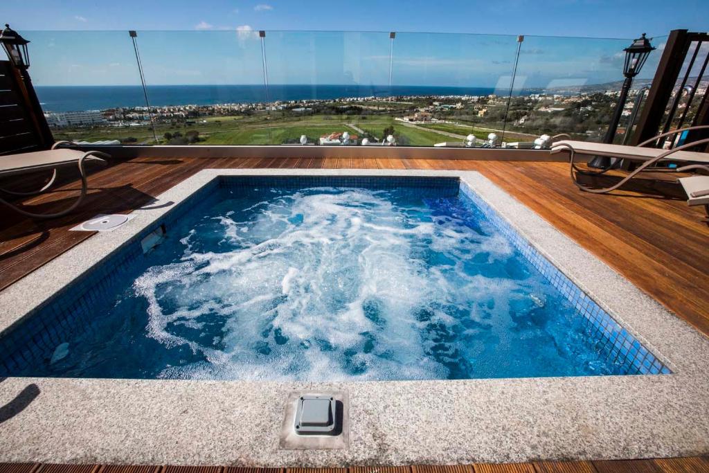 a swimming pool with a view of the ocean at Diamond Townhouse 17 in Paphos