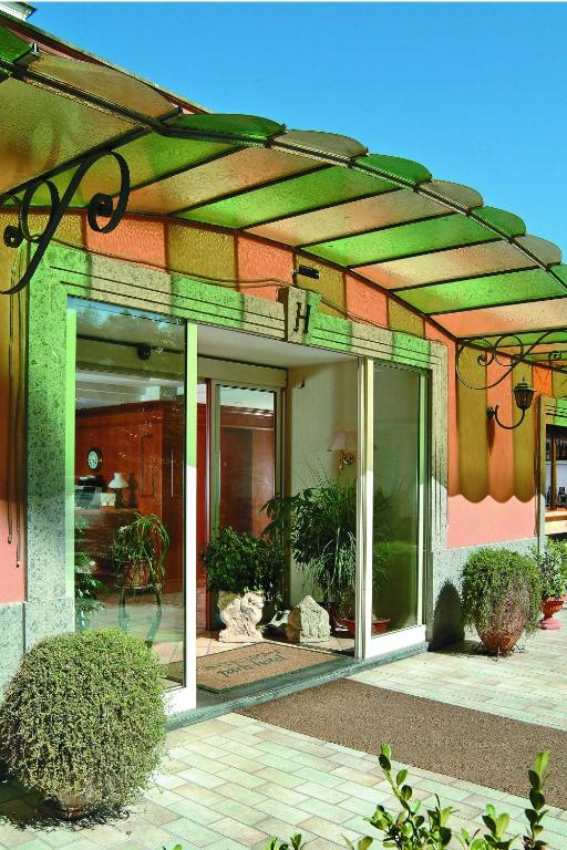 a building with awning on the side of it at Montespina Park Hotel in Naples