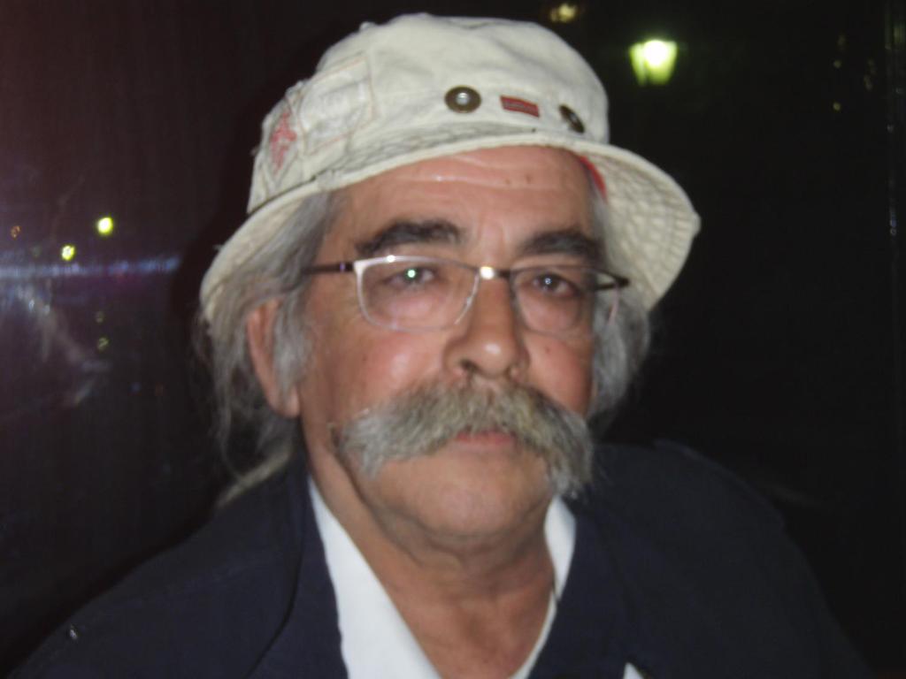 an older man wearing a hat and glasses at Aposperitis Rooms & Apartments in Kini