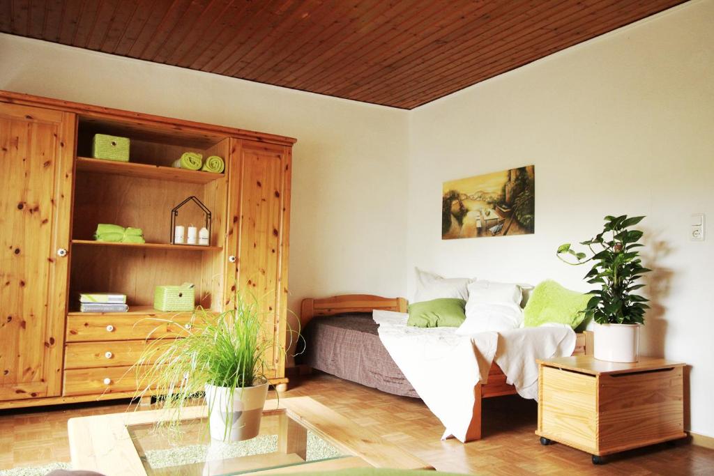 a bedroom with a bed and a wooden cabinet at Ferienwohnung Ulrichstein/ Bobenhausen II in bobenhausen Zwei