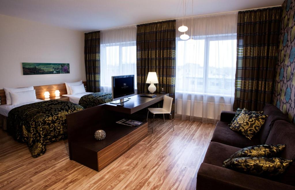 Postel nebo postele na pokoji v ubytování Ararat All Suites Hotel Klaipeda