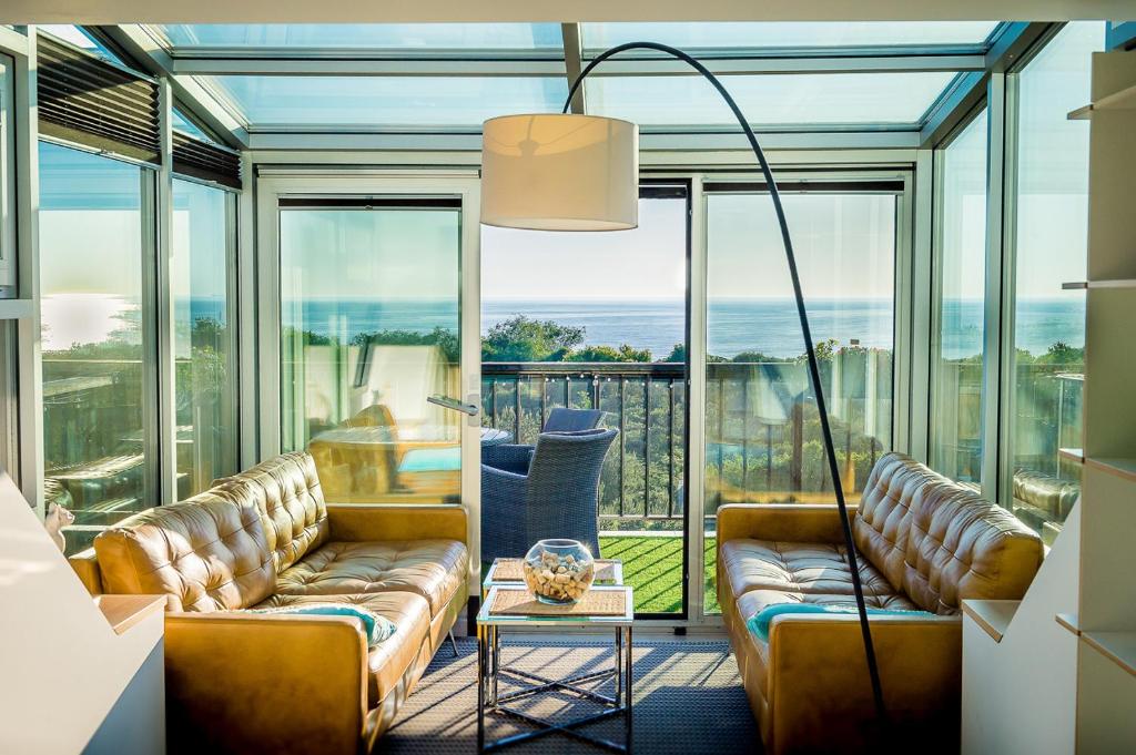 a living room with couches and a view of the ocean at Sand in the City in Klaipėda