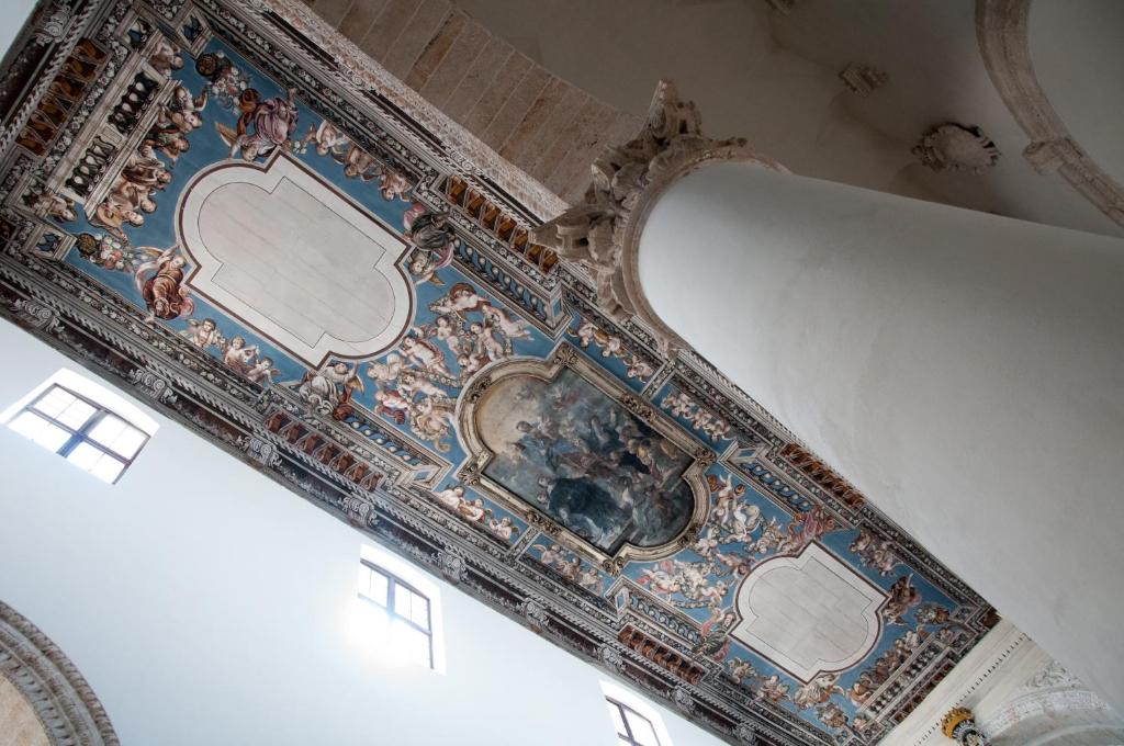 a ceiling of a building with a painting on it at Casetta San Domenico apartment in Monopoli