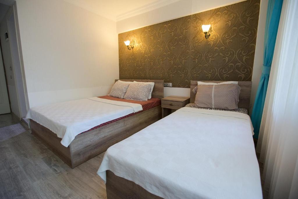 Postel nebo postele na pokoji v ubytování Ozbay Hotel