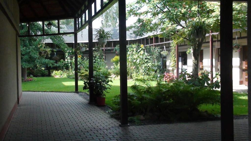 an outside view of a building with a courtyard with plants at Pension im Adventhaus in Lutherstadt Wittenberg