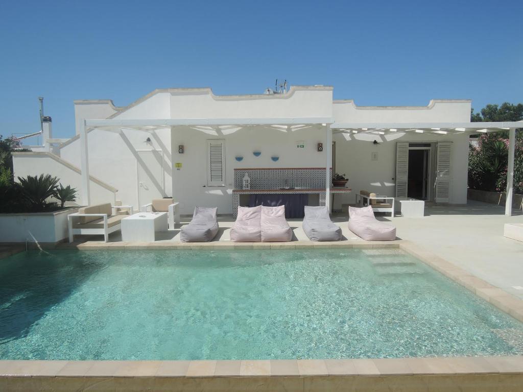 a villa with a swimming pool and a house at I Mirti - Home Holiday in Marina di Mancaversa