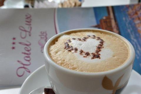 a cup of coffee with a heart drawn on it at Hotel Lux in Caorle