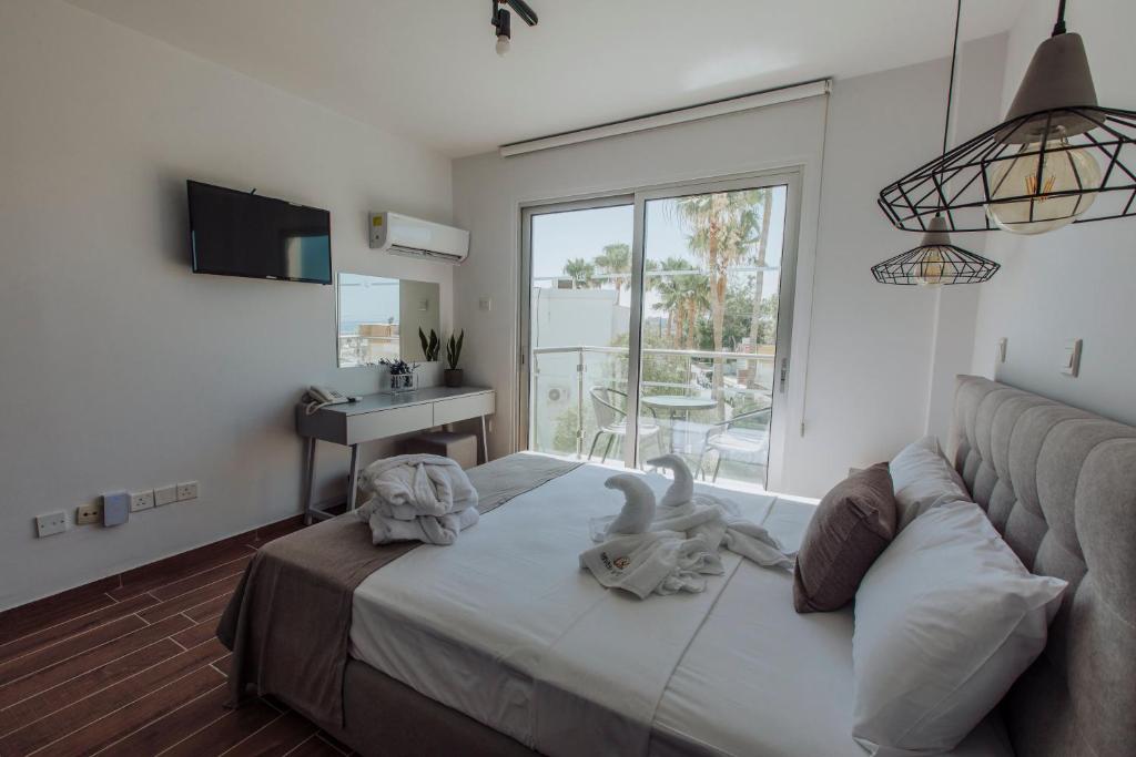 a bedroom with a bed with two animals on it at River View Boutique Apts in Ayia Napa