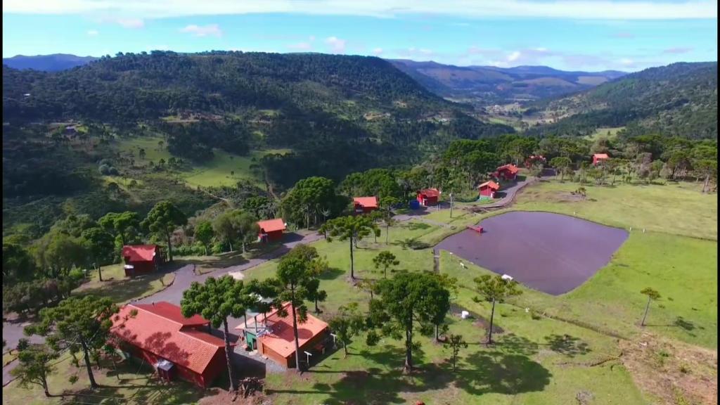 an aerial view of a farm with a lake at Pousada Lago da Colina in Urubici