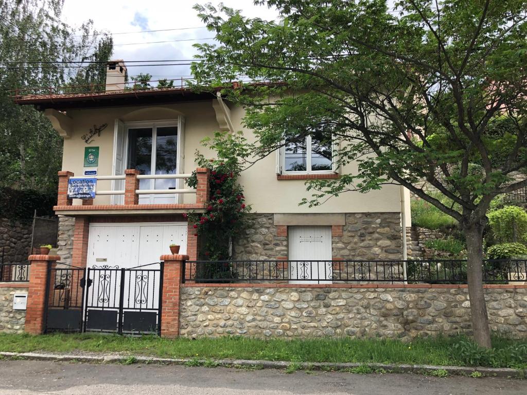 a house with a stone wall at SARL l'Alzina in Vernet-les-Bains