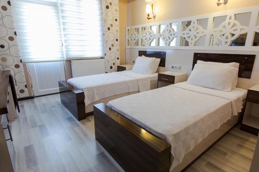 Postel nebo postele na pokoji v ubytování Ozbay Hotel