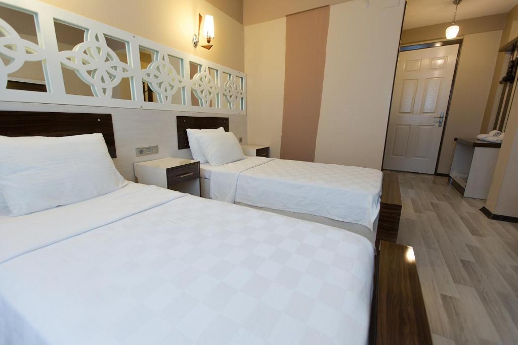 Postel nebo postele na pokoji v ubytování Ozbay Hotel
