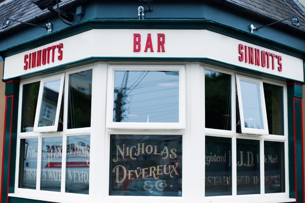 a store front of a bar with windows at Sinnotts Bar in Wexford