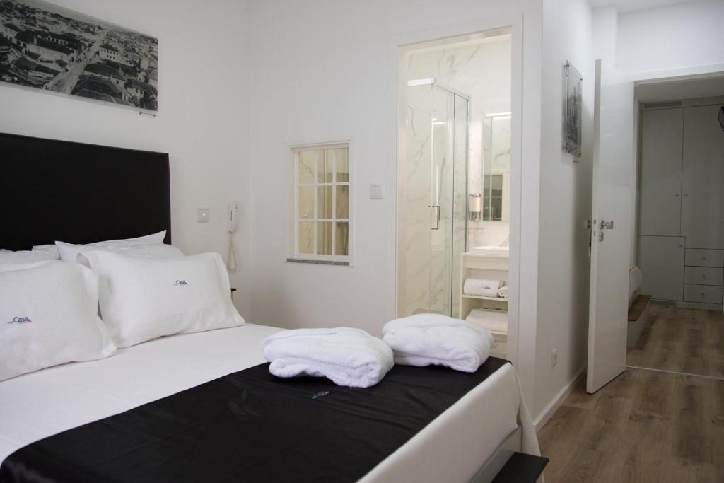 two towels are sitting on a bed in a bedroom at myCasa in Espinho