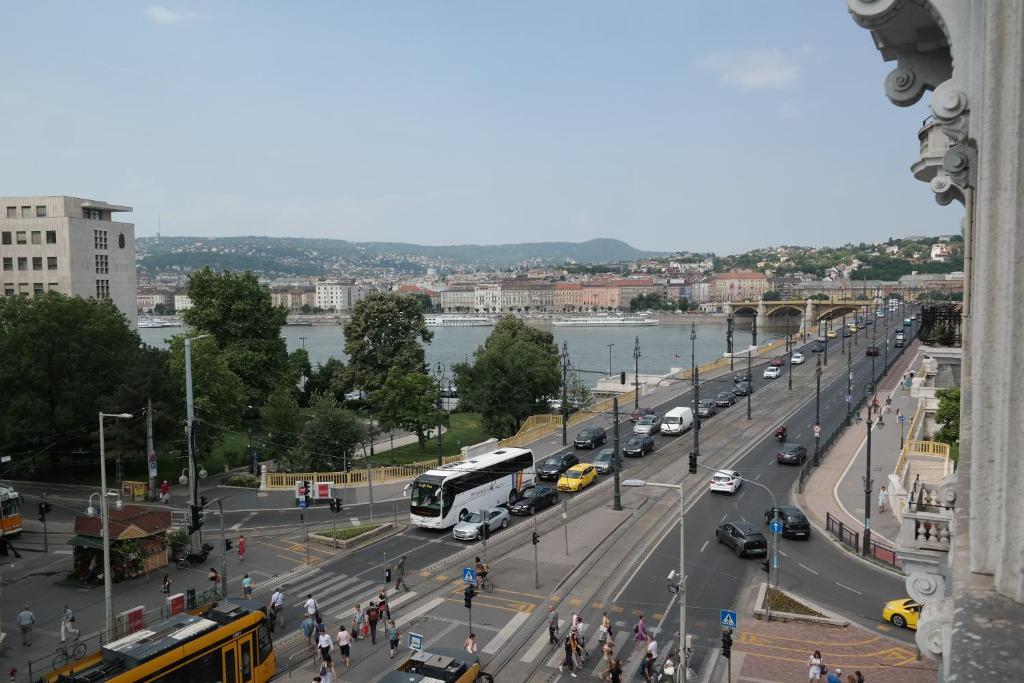 a busy city street with cars and a bus at Budapest Danube Panorama Apartment in Budapest