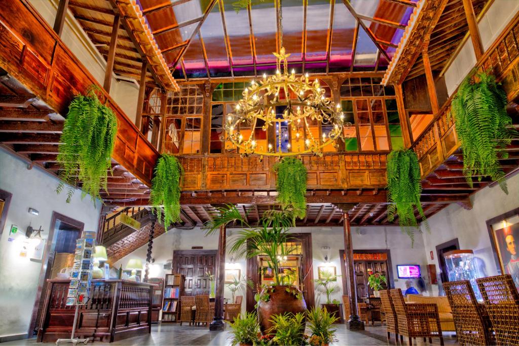 a large room with a large chandelier in a building at Hotel Marquesa in Puerto de la Cruz