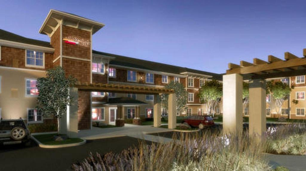 a rendering of a apartment building with a parking lot at Ledgestone Hotel in Yakima