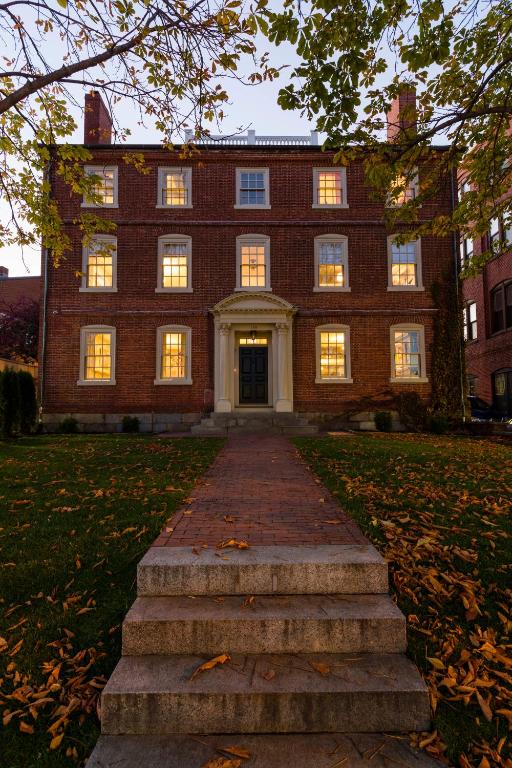 a large brick building with stairs in front of it at The Merchant in Salem