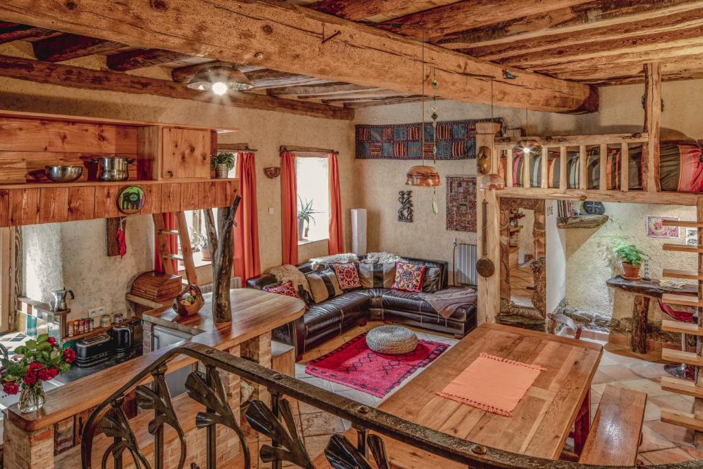 a living room with a couch and a table at The Dragon Barn - Studio in Ascou