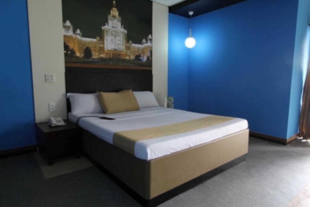 Un pat sau paturi într-o cameră la Eurotel Araneta Center Cubao