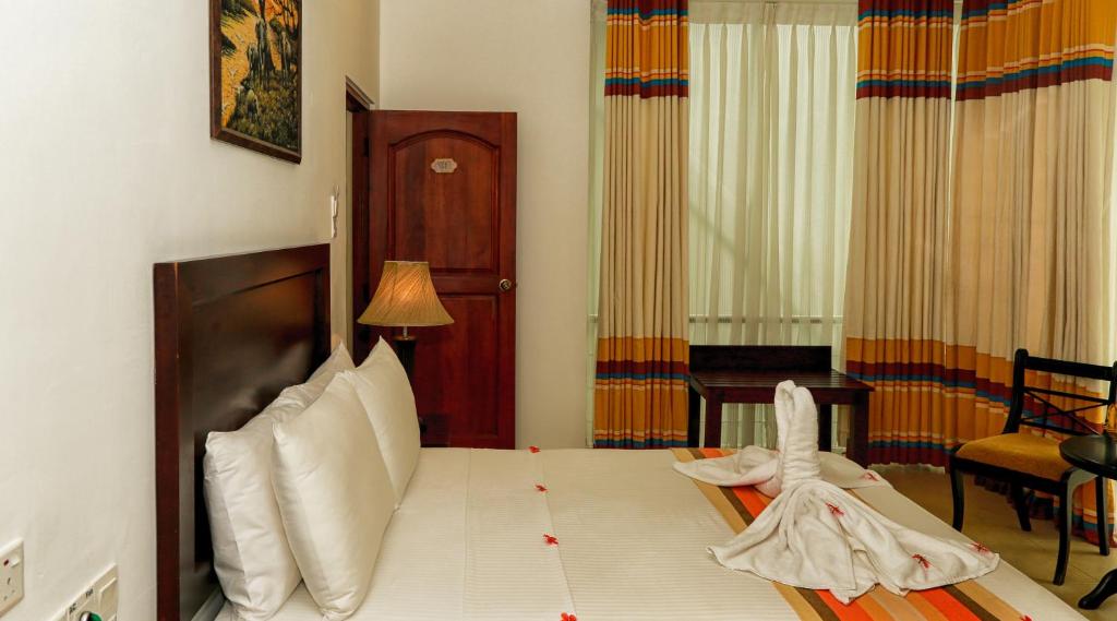 Postel nebo postele na pokoji v ubytování Oak Ray Serene Garden Hotel