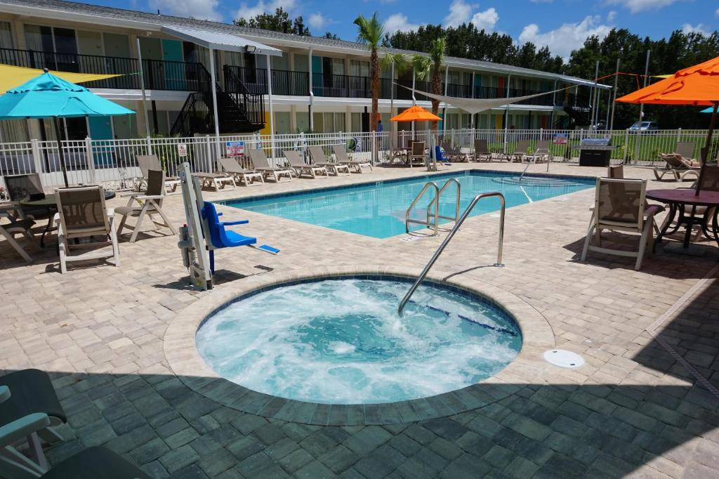 una piscina con bañera de hidromasaje frente a un hotel en Smart Stay Inn - Saint Augustine, en St. Augustine