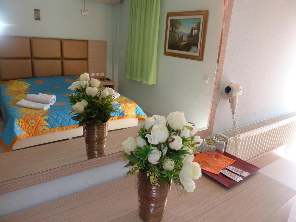 Postel nebo postele na pokoji v ubytování Hotel White Rose Beach