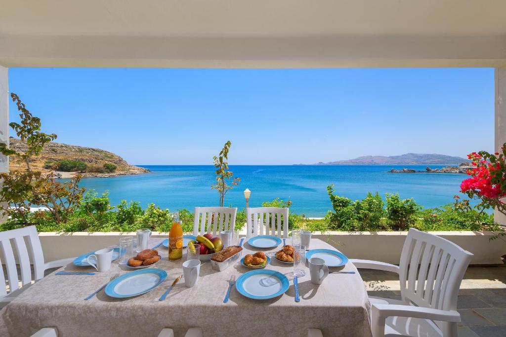 a dining table with a view of the ocean at Haraki Sea View Luxury House in Rhodes Town