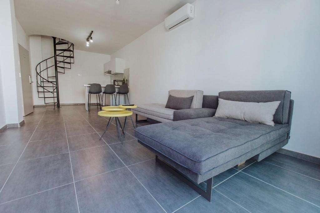 a living room with a couch and a table at River View Boutique Apts in Ayia Napa