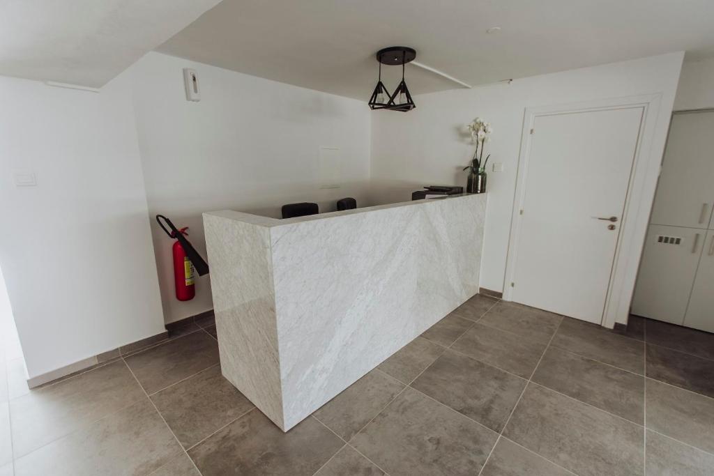 a kitchen with white walls and a counter top at River View Boutique Apts in Ayia Napa