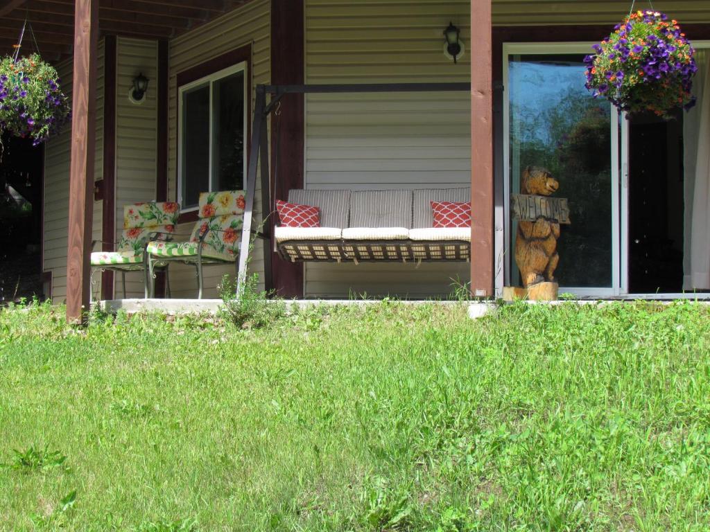 a porch with a bench and a teddy bear on it at Peaceful 3 bdrm Alaskan getaway in Wasilla