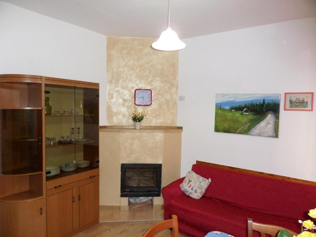 sala de estar con sofá rojo y chimenea en Casa Ferrara, en Francavilla in Sinni