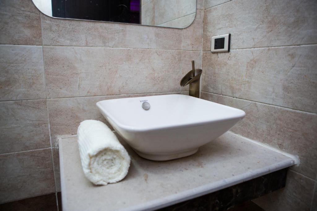 a white toilet sitting in a bathroom next to a sink at Hayat Pyramids View Hotel in Cairo
