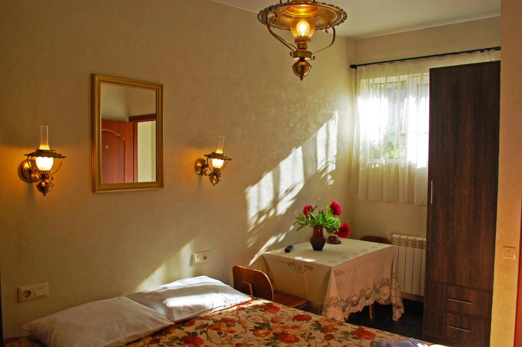 a room with two beds and a table and a mirror at Hotel Hata in Sheremetyevo