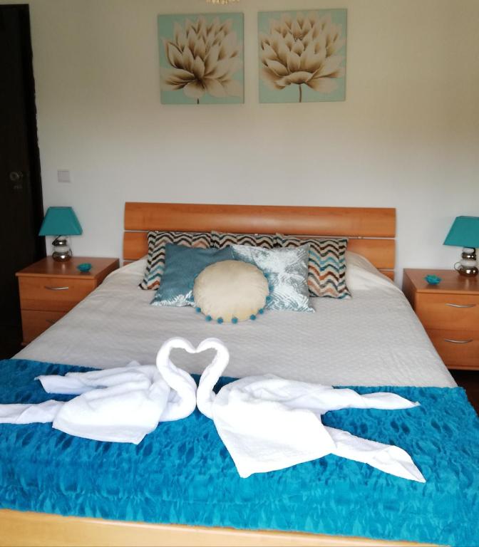 a bed with two white towels on it at Casa da Vista Rio in Amora