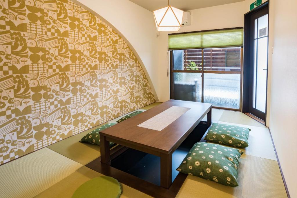 a dining room with a table and a window at Bijou Suites Kakomi in Osaka