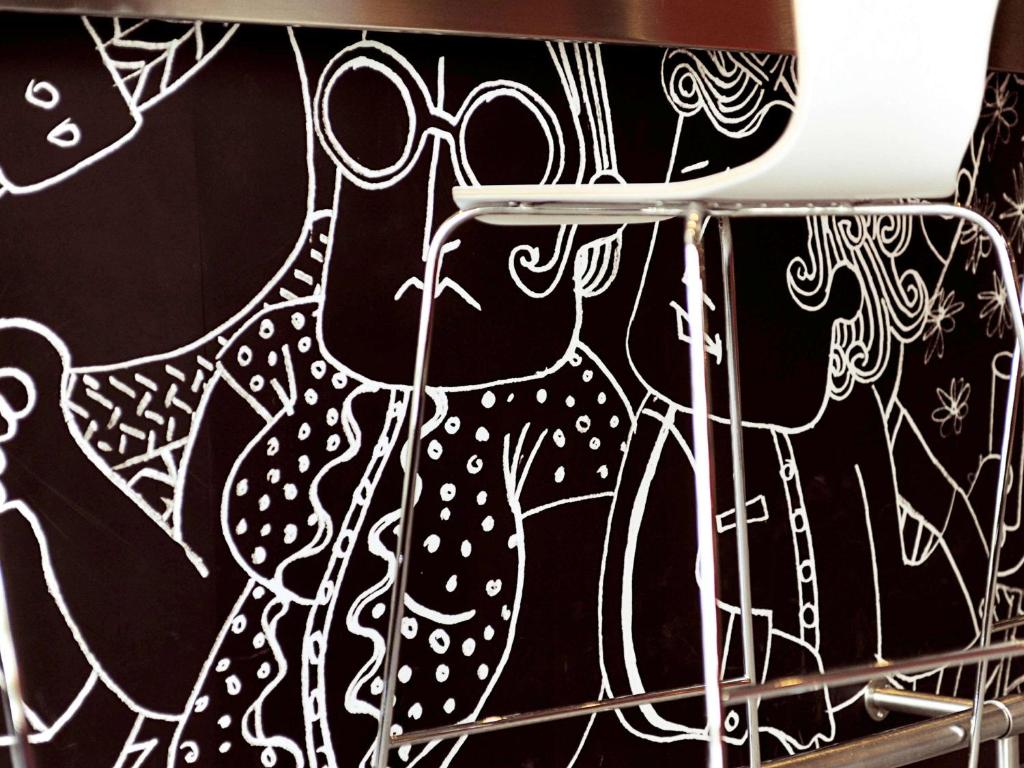 a wall with a drawing of a cow on it at ibis Birmingham Centre New Street Station Hotel in Birmingham