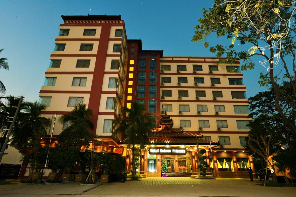 a large building in front of a building at Sakura Princess Hotel in Mandalay