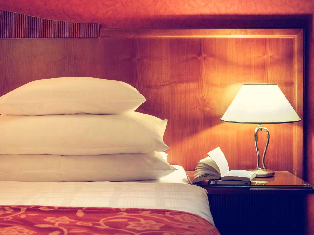 Postel nebo postele na pokoji v ubytování Hotel Josefshof am Rathaus