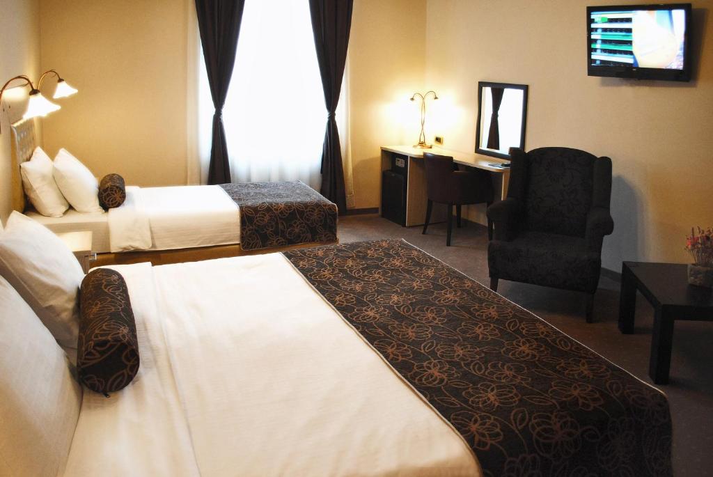 Postel nebo postele na pokoji v ubytování Belgrade City Hotel