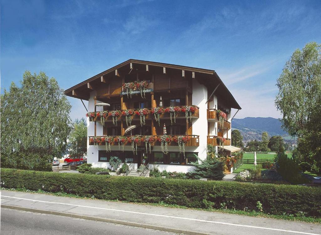 een gebouw met veel planten en bloemen erop bij Hotel-Pension-Ostler in Bad Wiessee