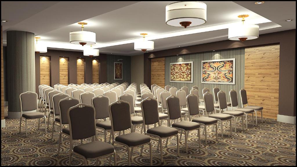 a conference room with rows of chairs in it at Grand Park Lara Hotel in Lara